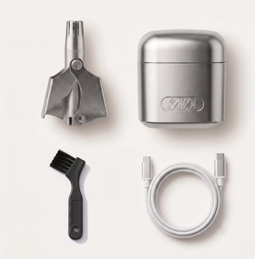 Set of grooming tools including a stainless steel nose trimmer, brush, beard shaver and cable on a white background